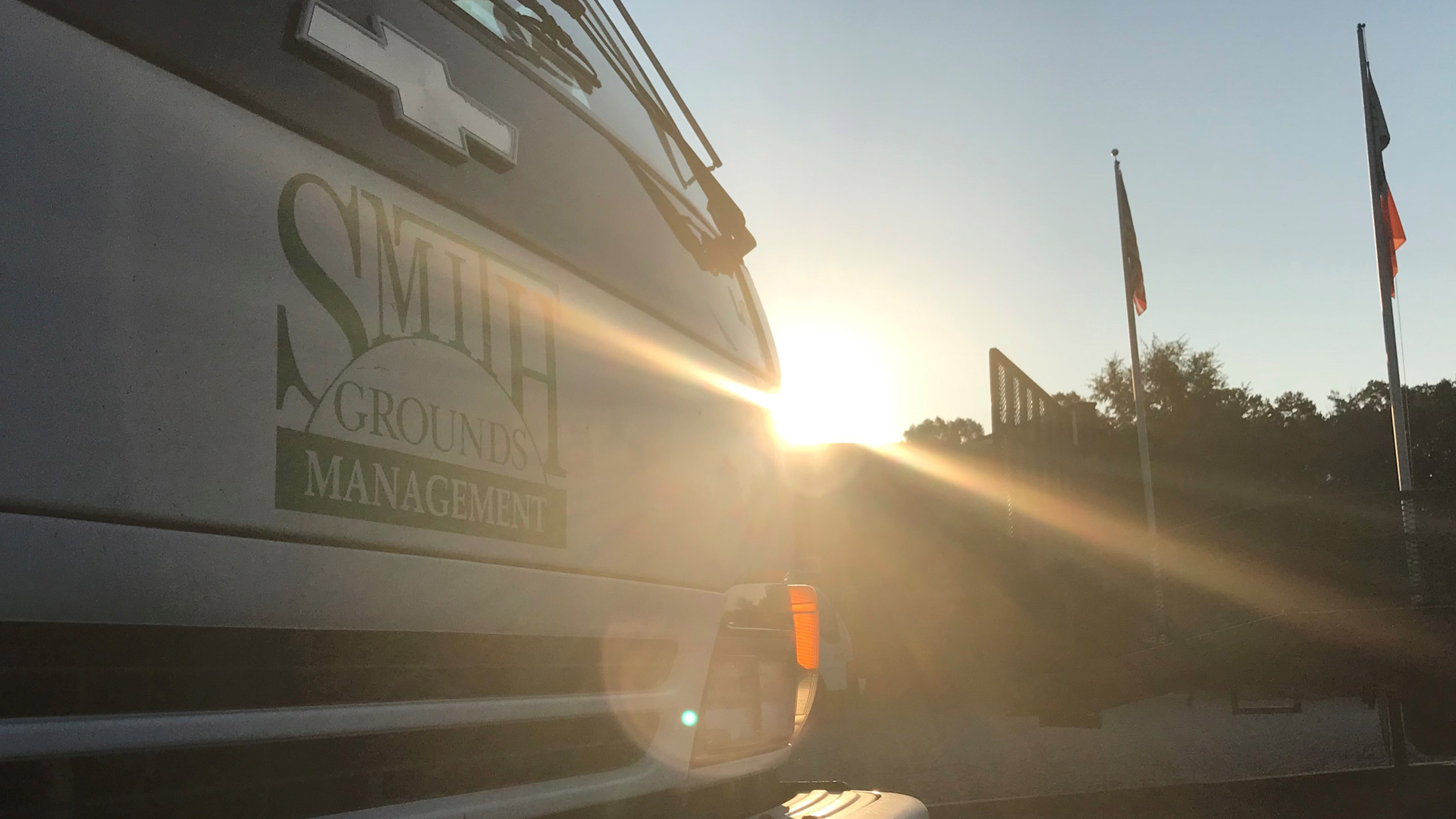 Branded work van shown with sun glare in the background in Matthews, NC.